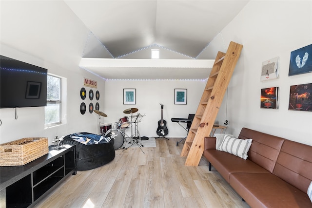 living room with high vaulted ceiling and light wood-type flooring