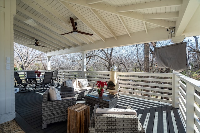 wooden terrace featuring an outdoor living space and ceiling fan