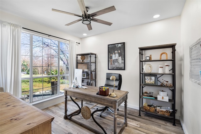 office area featuring light hardwood / wood-style flooring, ceiling fan, and plenty of natural light