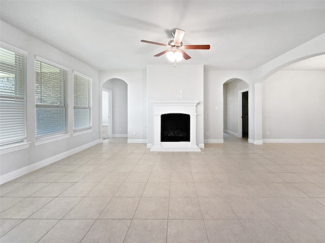 unfurnished living room with ceiling fan and light tile patterned floors