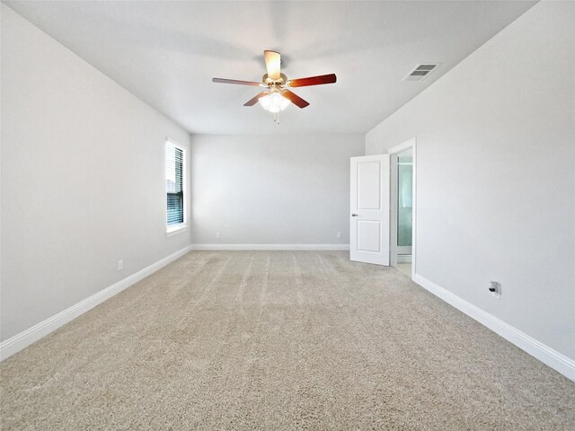 carpeted spare room featuring ceiling fan