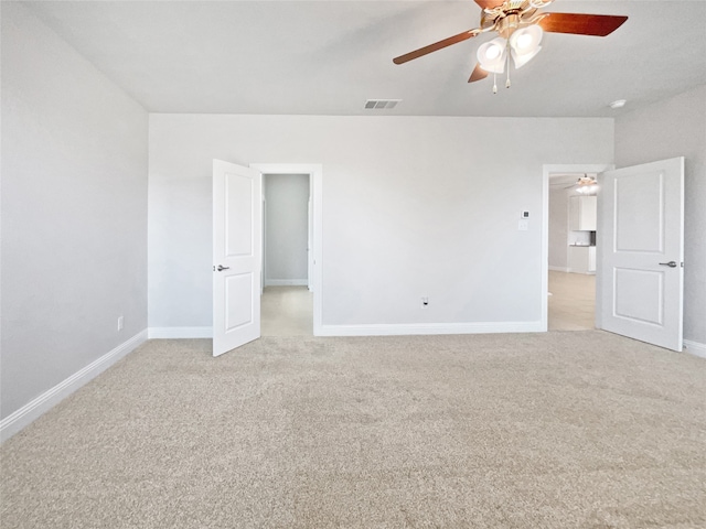 unfurnished room featuring ceiling fan and light colored carpet