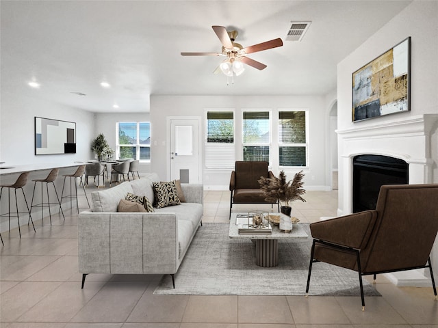 living room featuring light tile patterned floors and ceiling fan