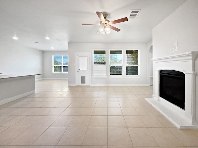 unfurnished living room featuring ceiling fan and light tile patterned floors