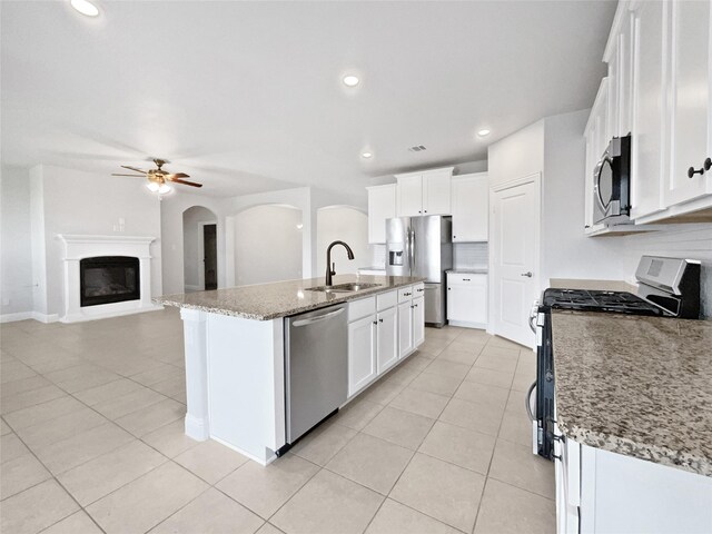 kitchen with ceiling fan, sink, a center island with sink, white cabinetry, and stainless steel appliances