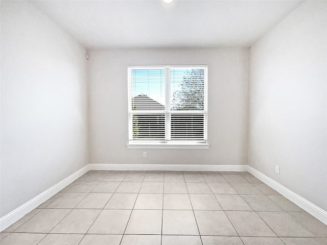 unfurnished room with light tile patterned floors