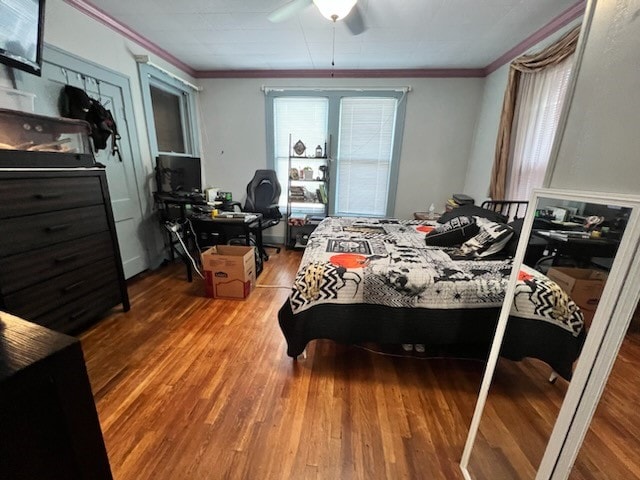 bedroom with ceiling fan, hardwood / wood-style flooring, and ornamental molding