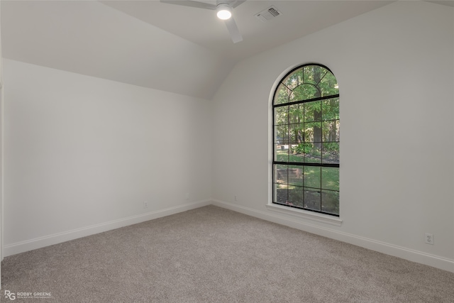 spare room with ceiling fan, carpet flooring, and vaulted ceiling