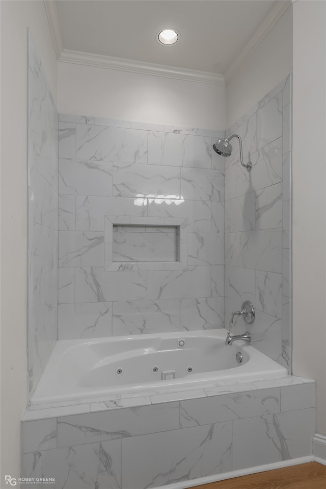 bathroom featuring tiled shower / bath and ornamental molding