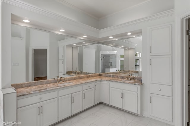 bathroom with ornamental molding, vanity, and a shower with shower door