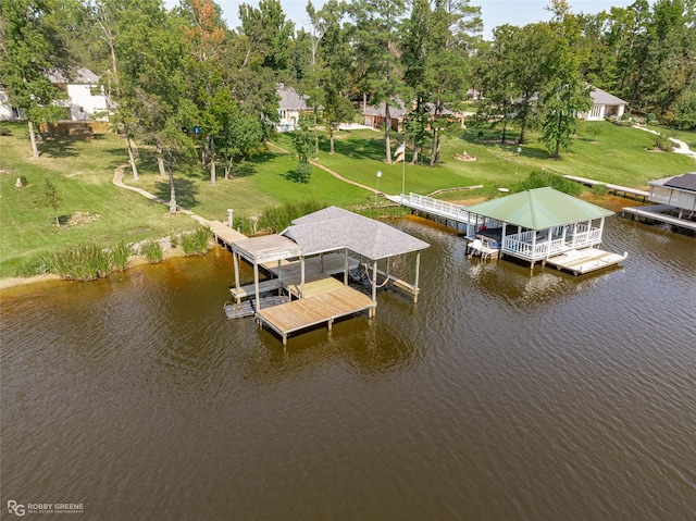 view of dock with a water view and a lawn