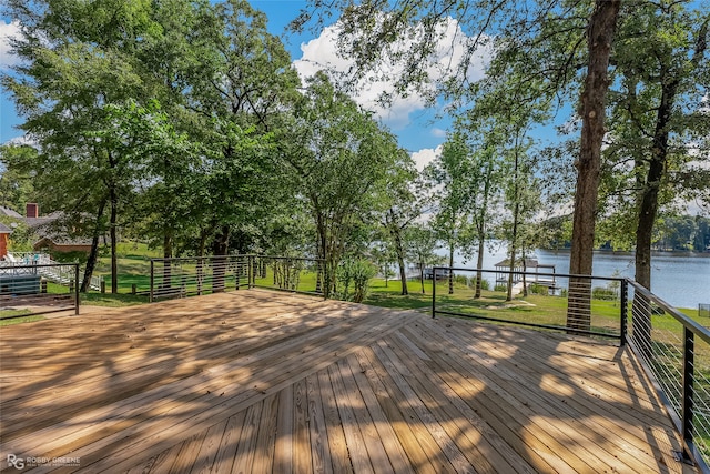 deck featuring a water view and a lawn