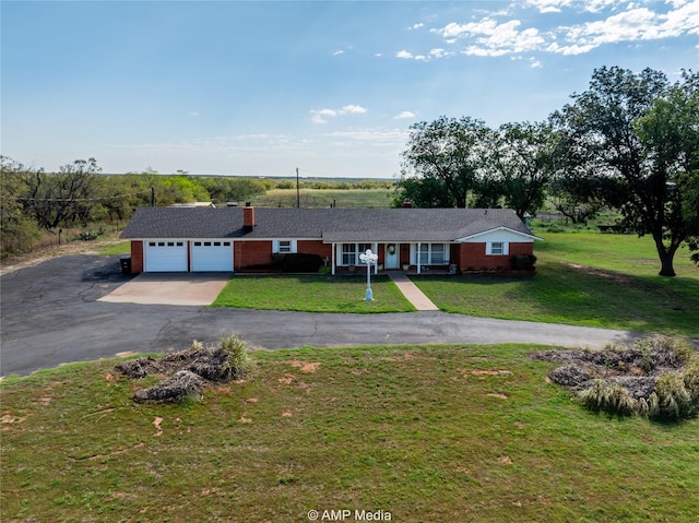 single story home with a garage and a front lawn