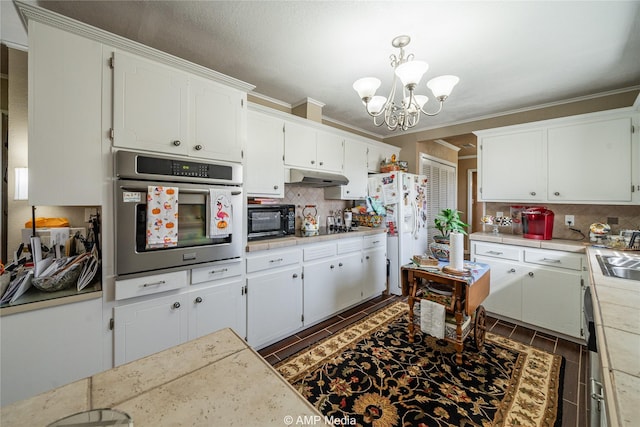 kitchen with hanging light fixtures, white cabinetry, tasteful backsplash, and black appliances