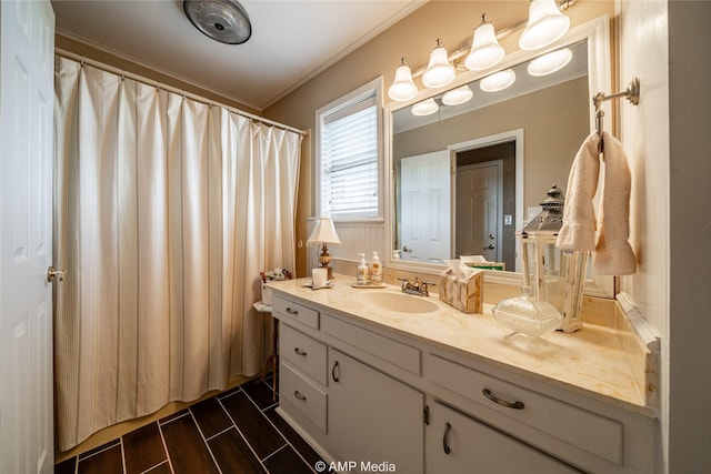 bathroom with ornamental molding and vanity