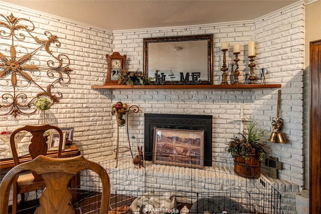 interior space featuring crown molding, a fireplace, a textured ceiling, and brick wall