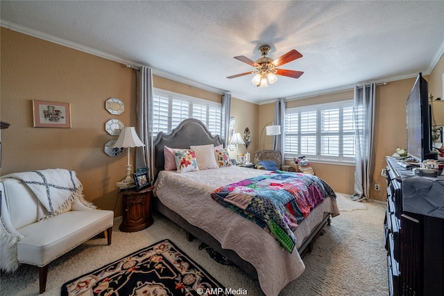 bedroom with ceiling fan, ornamental molding, carpet floors, and multiple windows