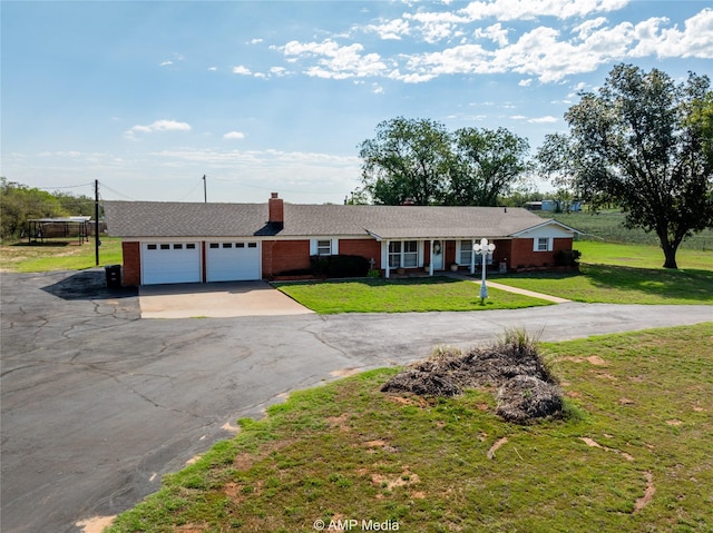 ranch-style house with a garage and a front yard