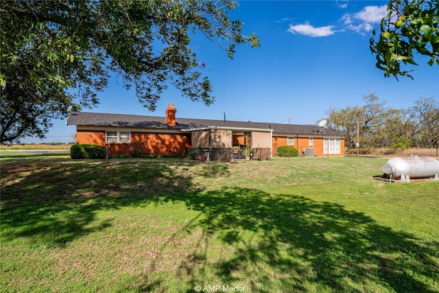 rear view of house with a lawn