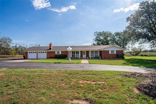 single story home with a garage and a front lawn