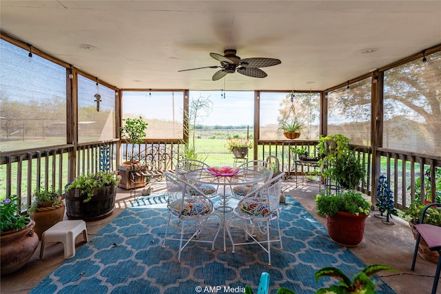 sunroom / solarium featuring ceiling fan