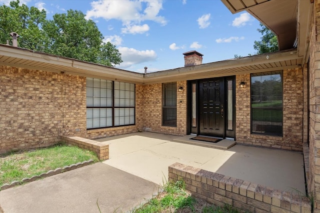 property entrance featuring a patio