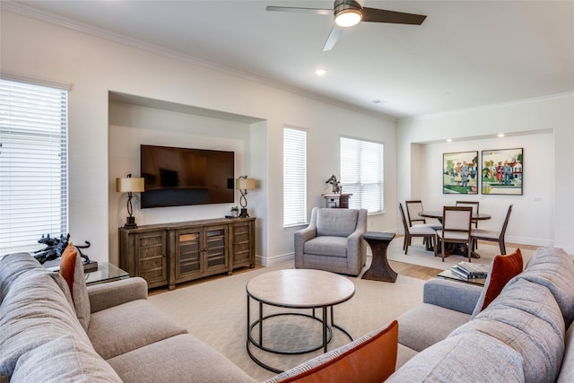 living room with ceiling fan and crown molding