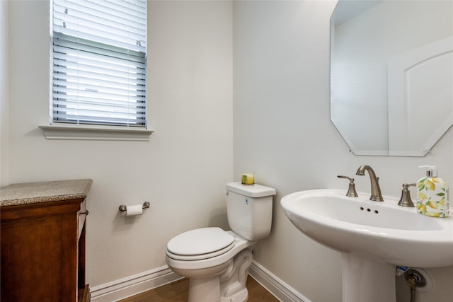 bathroom featuring hardwood / wood-style floors, toilet, and sink