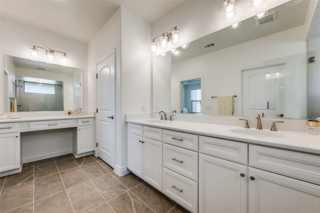 bathroom with tile patterned floors, vanity, and a shower