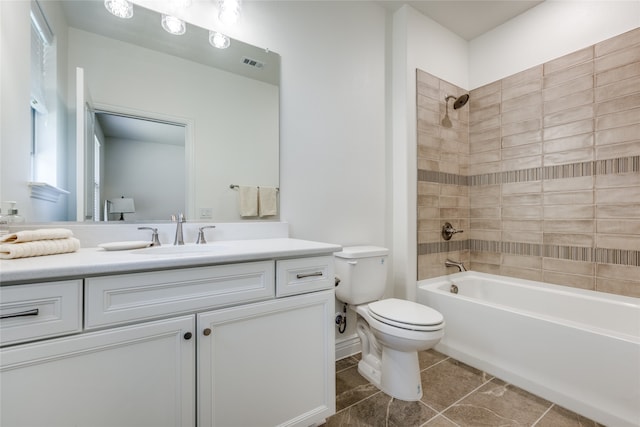 full bathroom featuring toilet, tile patterned flooring, vanity, and tiled shower / bath