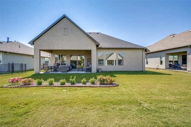 back of property with a lawn, outdoor lounge area, and a patio area