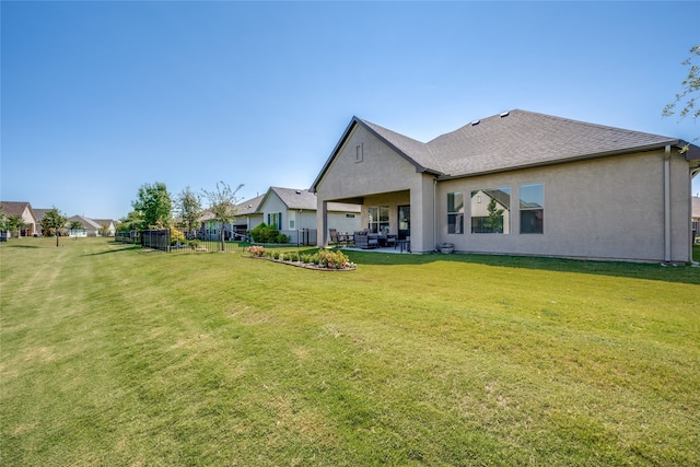 back of property featuring a yard and a patio