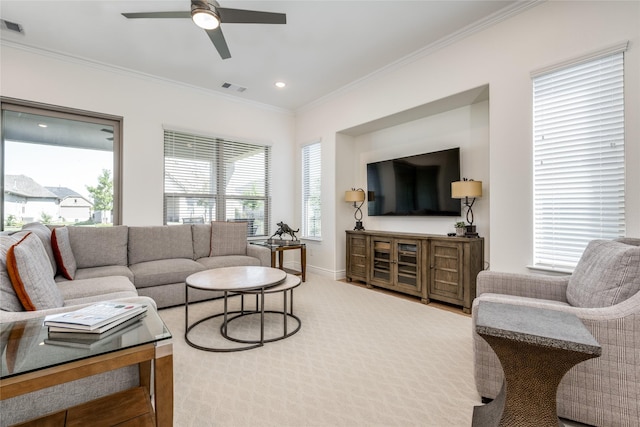 living room featuring crown molding, plenty of natural light, and ceiling fan