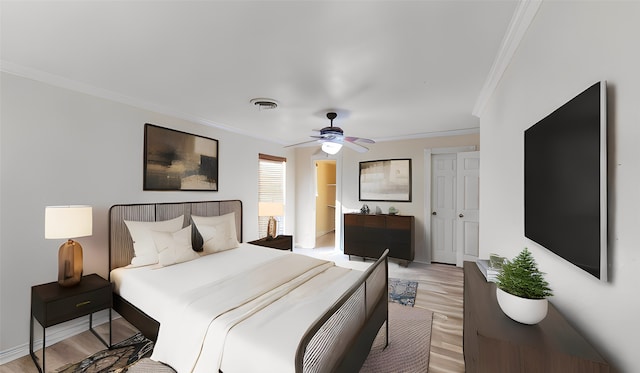 bedroom featuring ceiling fan, ornamental molding, and light hardwood / wood-style floors