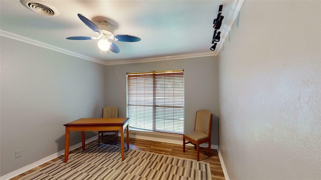 office space featuring crown molding, ceiling fan, and light hardwood / wood-style flooring