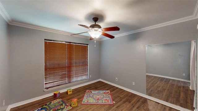 unfurnished room featuring ornamental molding, dark wood-type flooring, and ceiling fan