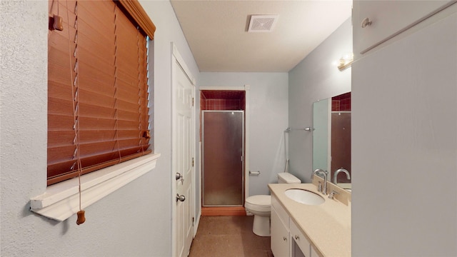 bathroom featuring walk in shower, vanity, and toilet