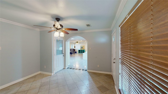 tiled spare room with ceiling fan and ornamental molding