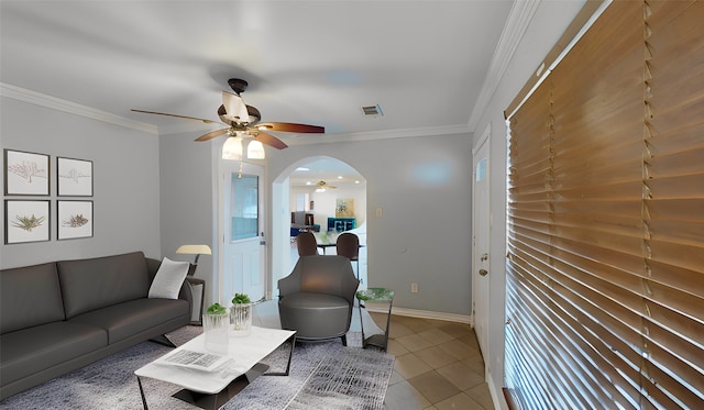 living room with tile patterned flooring, ornamental molding, and ceiling fan