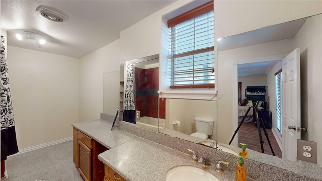 bathroom with hardwood / wood-style floors, vanity, and toilet