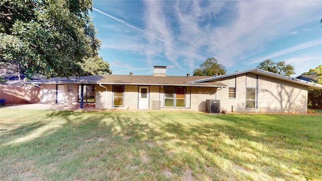 rear view of house with a yard, central AC unit, and a patio area