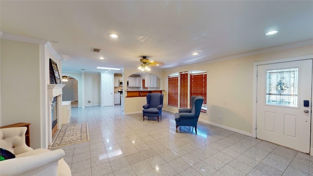 foyer entrance featuring crown molding and ceiling fan