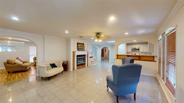 interior space with ornamental molding and ceiling fan