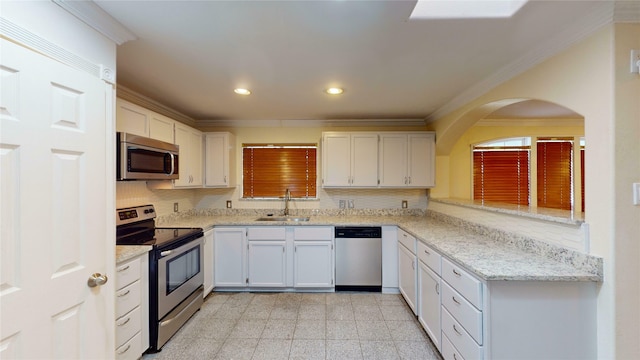 kitchen with crown molding, sink, stainless steel appliances, and white cabinets