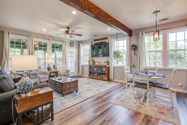 living room with baseboards, visible vents, wood finished floors, and recessed lighting