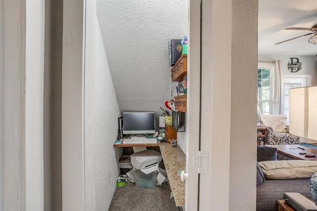 interior space with ceiling fan