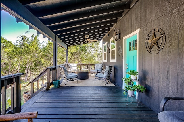 wooden deck with an outdoor living space with a fire pit