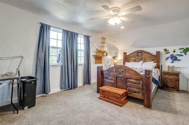 bedroom featuring ceiling fan, a textured ceiling, light carpet, baseboards, and vaulted ceiling