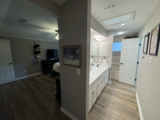 bathroom featuring wood-type flooring, ceiling fan, and vanity