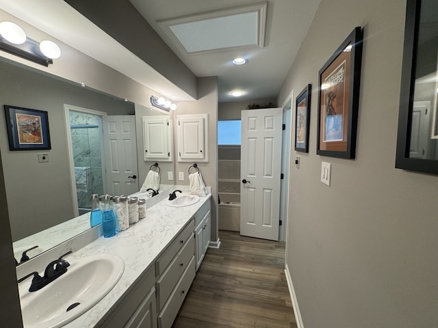 bathroom with a shower, vanity, and wood-type flooring